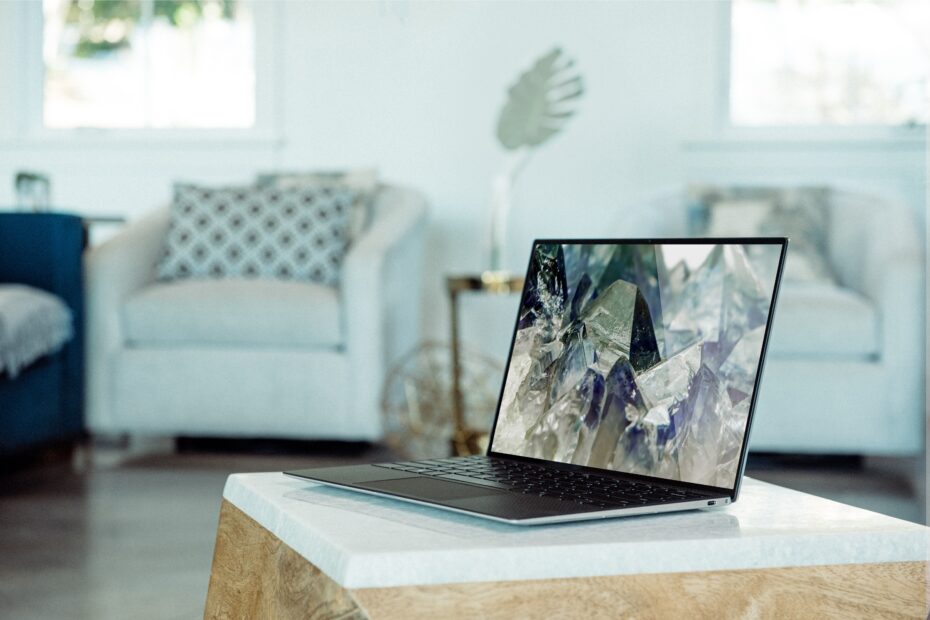 a livingroom background with a windows laptop on the coffee table