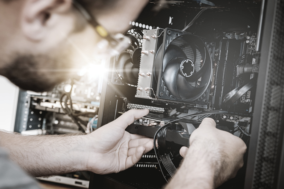 A Man placing a GPU in a PC